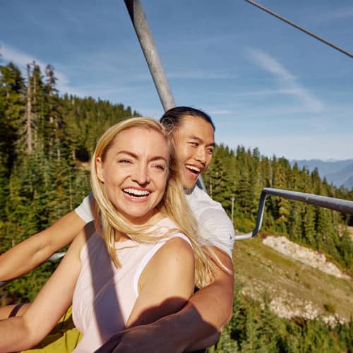 couple on chair lift looking at view