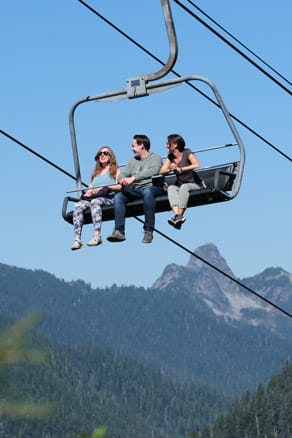 family on chairlift in the summer