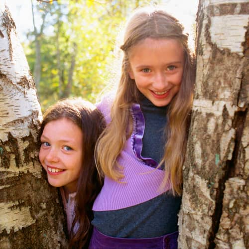 young girls playing in trees